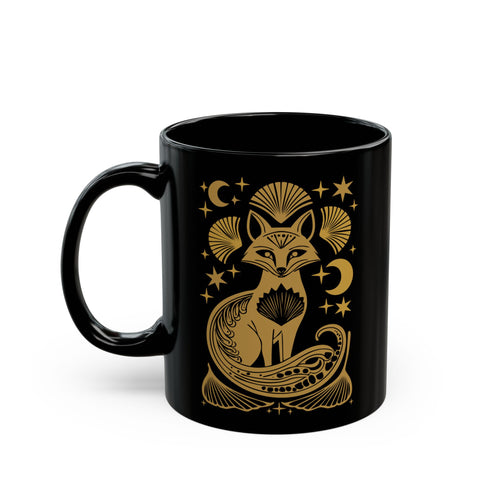 A black ceramic mug featuring a stylized golden fox design surrounded by Art Deco ginkgo fans, crescent moons, and stars. The mug has a glossy finish and ergonomic handle.
